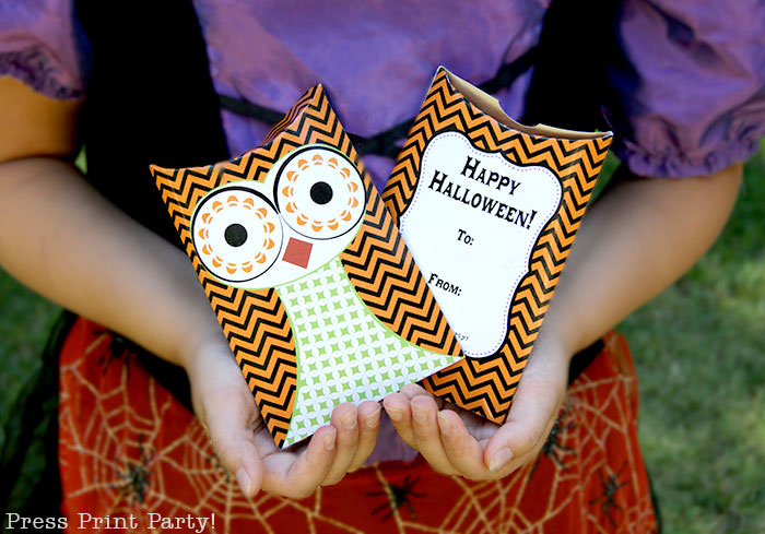 Free printable owl halloween treat boxes, favor bags, Orange, purple and green. Witch holding 2 owl pillow boxes by Press Print Party!