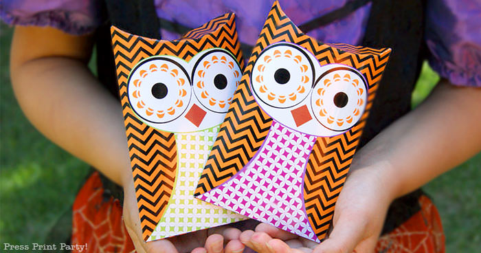 Free printable owl halloween treat boxes, favor bags, Orange, purple and green. Witch holding 2 owl pillow boxes by Press Print Party!