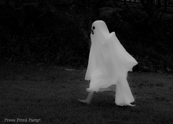 Easy ghost costume tutorial - kid in ghost costume walking. kid in ghost sheet costume. bed sheet ghost costume DIY Press Print Party