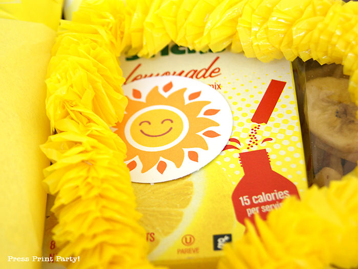 Yellow lei and lemonade with happy sun tag