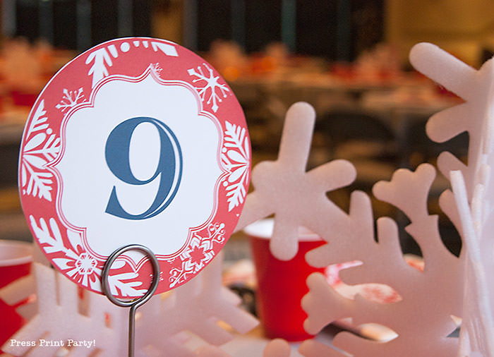 DIY Christmas Centerpiece Ideas red snowflake red and white table number. White foam snowflakes on table. table number 9 - Press Print Party!