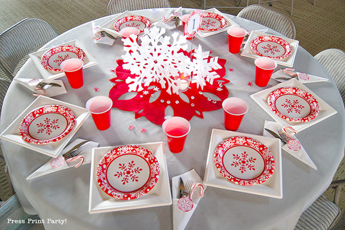 DIY Christmas Centerpiece Ideas with candles red snowflake red and white christmas paper plates with red cup. grey tablecloth. red paper plates, big red felt snowflake - Press Print Party!