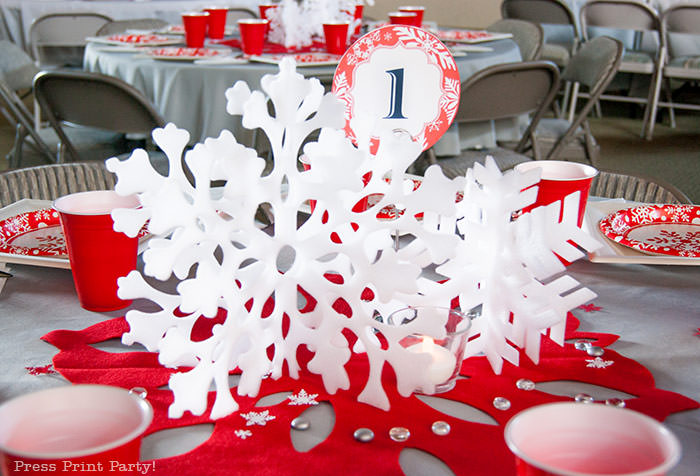 DIY Christmas Centerpiece Ideas red snowflake red and white christmas paper plates with red cup. grey tablecloth. big red felt snowflake - Press Print Party!