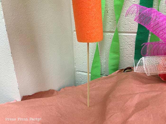 Pool noodle being attached to coral reef base