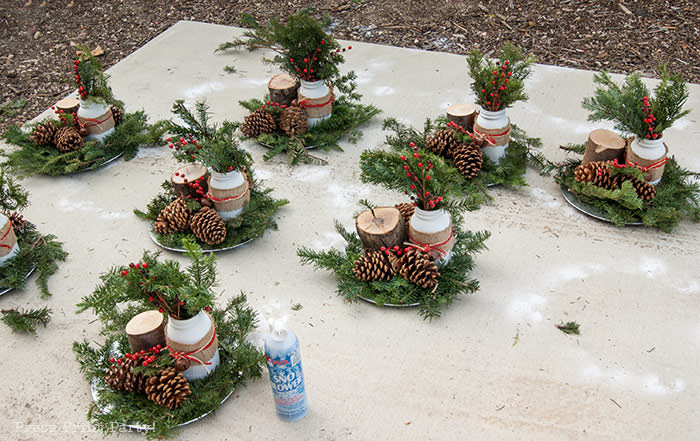 Rustic Christmas table centerpiece with greenery, rustic owl, white mason jar, pinecones, and berries. With a free music sheet table number printable download. With a brown tablecloth and music sheet place mats. Easy and cheap. by Press Print Party!