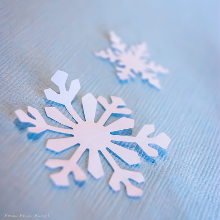 white snowflake punch confetti For Christmas table decor ideas blue and silver winter wonderland decorations. Christmas tablescape for large event christmas party, diy holiday table setting. by Press Print Party!