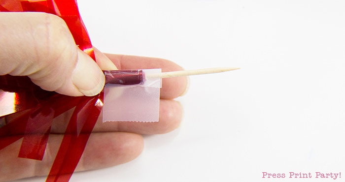 Taping your tassel cupcake toppers.