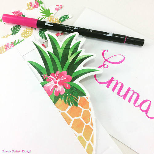 Pineapple party invitation in an envelope with a pink towbow pen