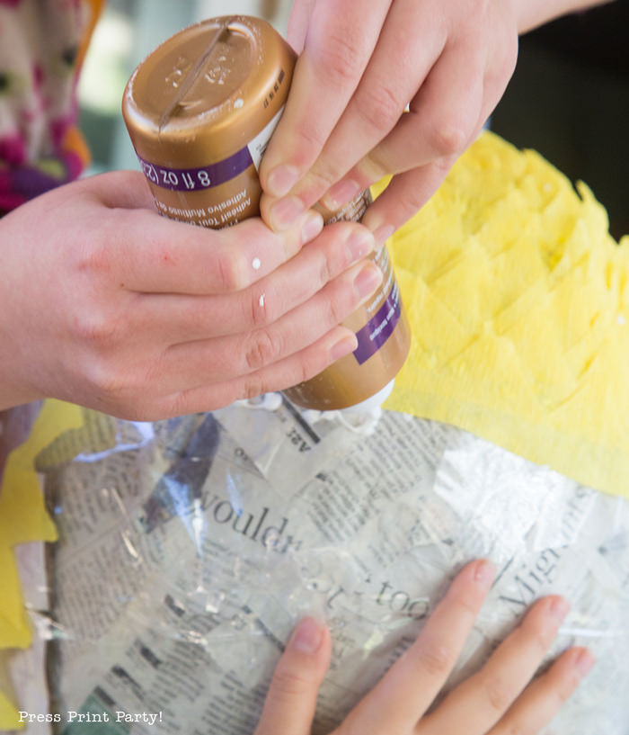 Pineapple Pinata Tutorial, the good, the bad and the funny! How to make a pineapple pinata. Gluing the streamers on the pinata