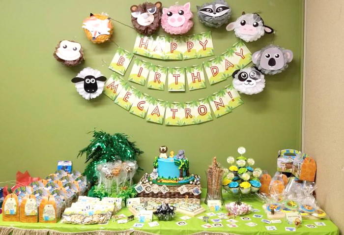 Jungle Party dessert table with banner on wall