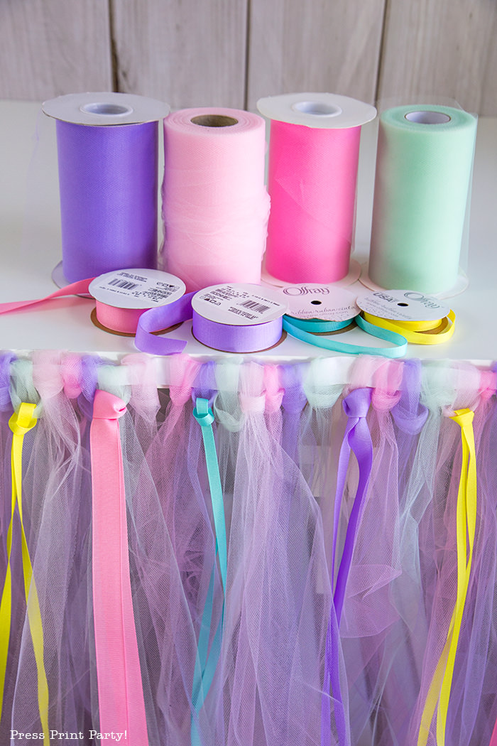 Tulle table skirt with rolls of tulle and ribbons