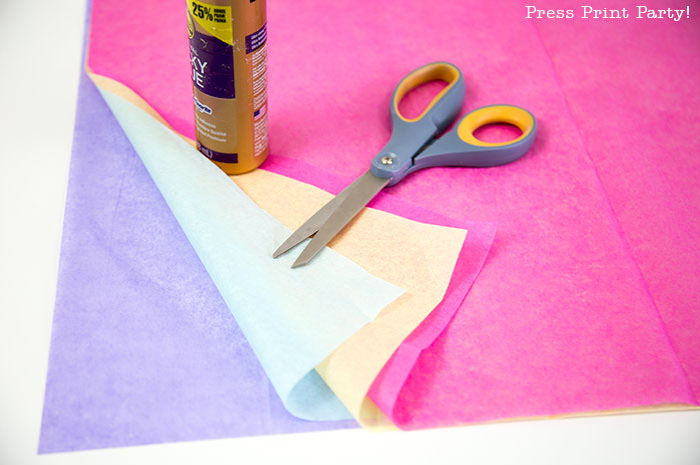 Tassel garland on buffet with text.Rainbow Tissue Paper Tassel Garland DIY. 4 colors of tissue paper