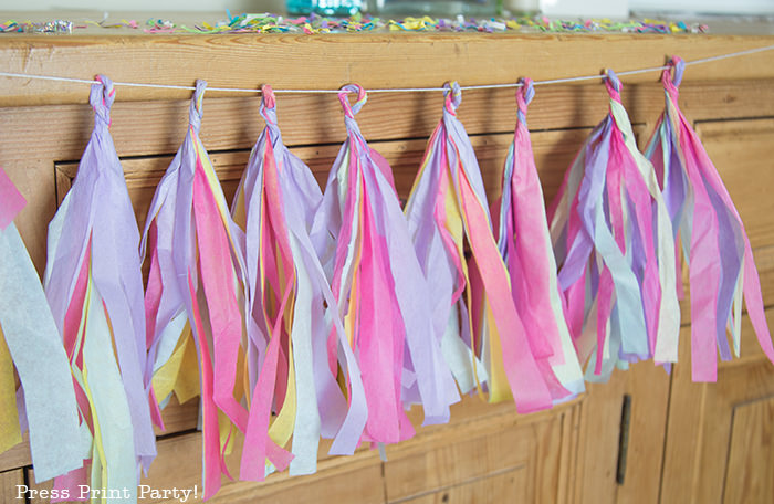 multicolored tissue paper tassels on mantel