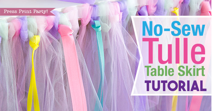 Tulle table skirt with rolls of tulle and ribbons with text