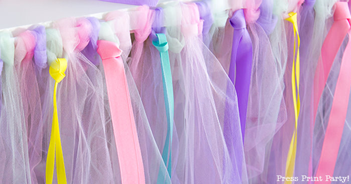 Tulle table skirt with rolls of tulle and ribbons