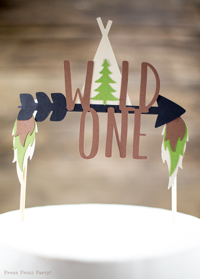 Cake with a Wild One cake topper with arrow and tipi.