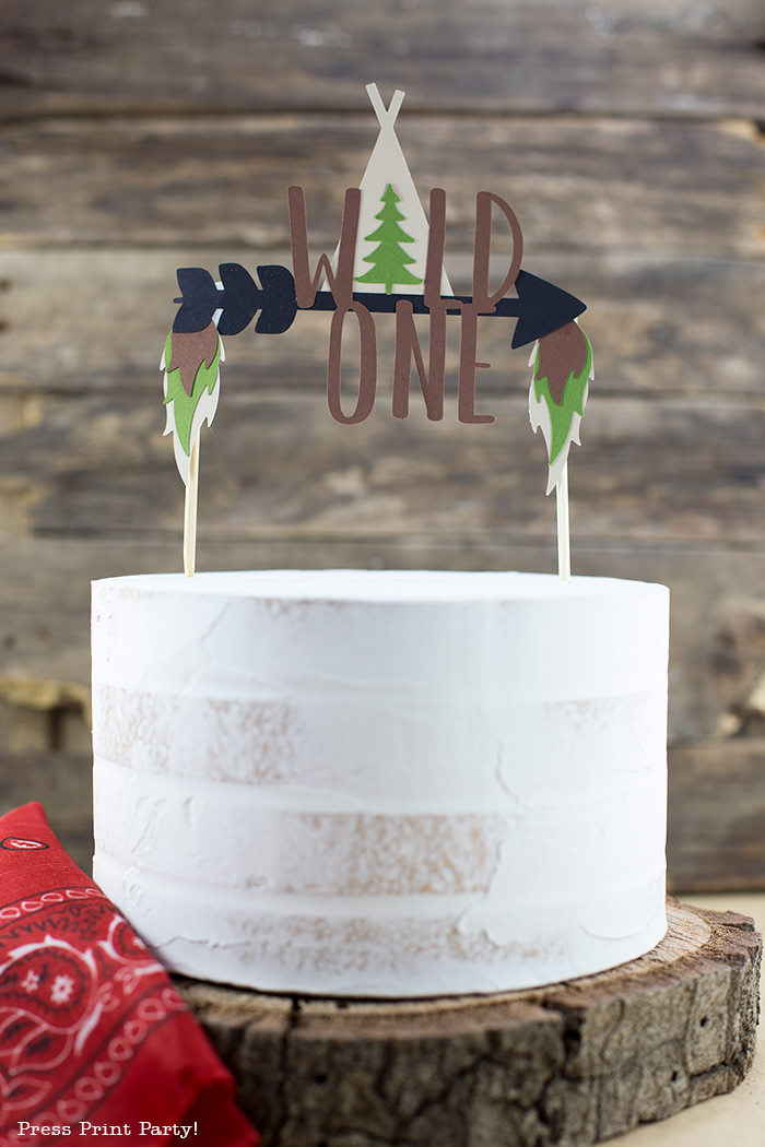 Cake with a Wild One cake topper with arrow and tipi.