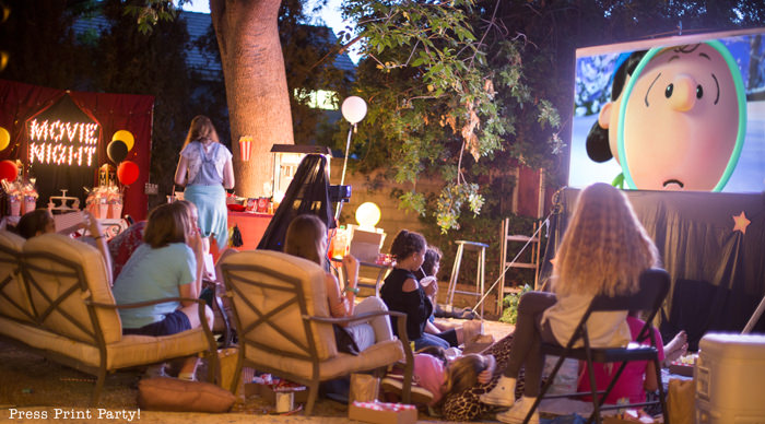 kids watching a movie at a backyard movie night - Press Print Party!