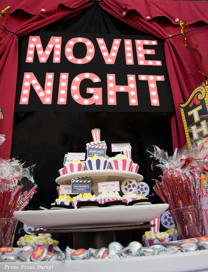 Movie night marquee. Backyard movie night dessert table.Backyard movie night party ideas - Movie night cupcakes with popcorn - Printables by Press Print Party!