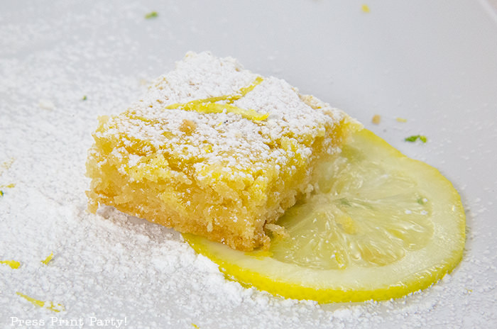 Lemon bar close up with lemon wedge