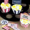 Movie night popcorn cupcakes on top of a movie reel. cupcake wrappers and toppers printables by Press Print Party!