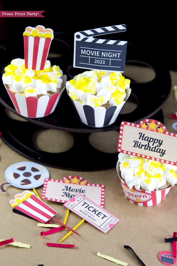 Movie night popcorn cupcakes on top of a movie reel. cupcake wrappers and toppers printables by Press Print Party!