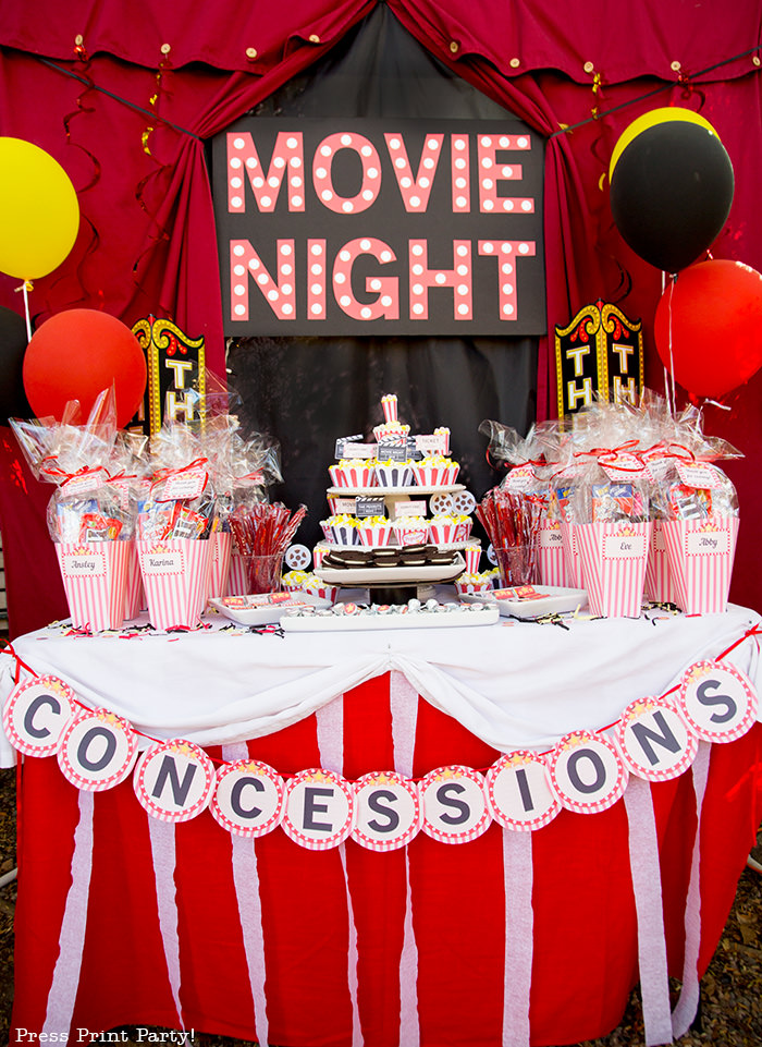 Backyard movie night dessert table with marquee.Backyard movie night party ideas - Movie night cupcakes with popcorn - Printables by Press Print Party!