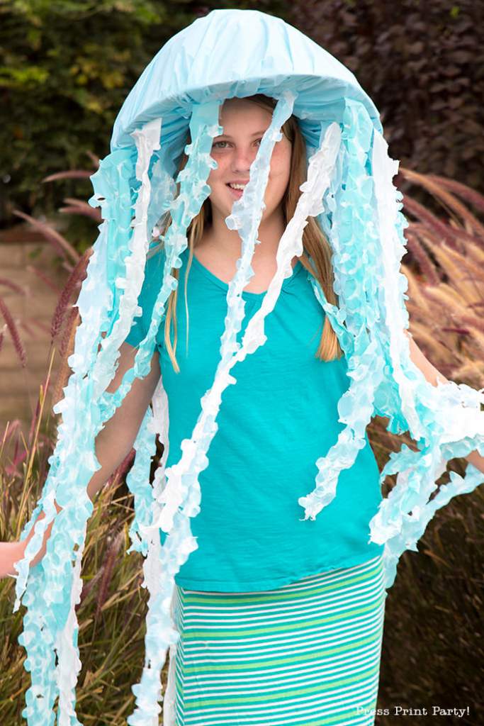 Girl with jellyfish costume for Halloween. Blue and white tentacles. Press Print Party!