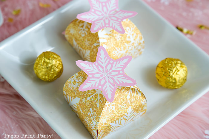 gold snowflake favor boxes with a pink interlocking snowflake on top. Press Print Party!