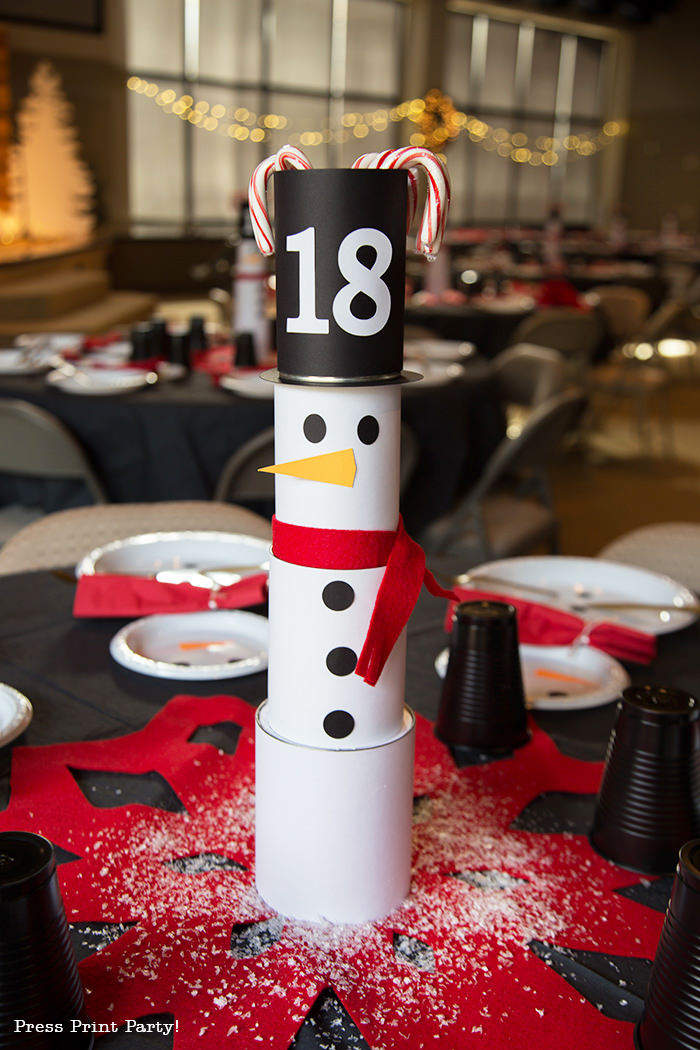 cute Christmas snowman craft table decor made with cans and felt scarf on a table with snowman made out of white plates - Press Print Party!