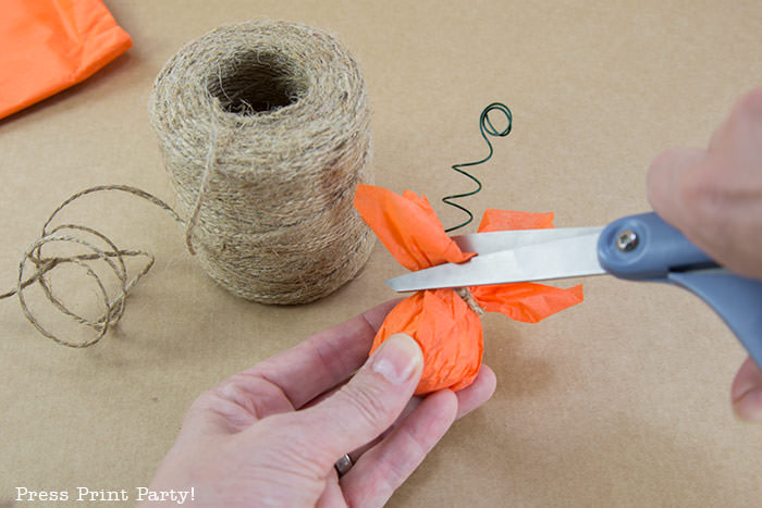Cutting the excess tissue paper on the pumpkin place card holder Press Print Party!