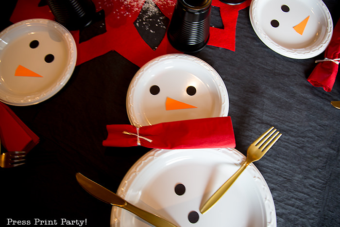 snowman made with white plates and a red napkin scarf - Press Print Party!