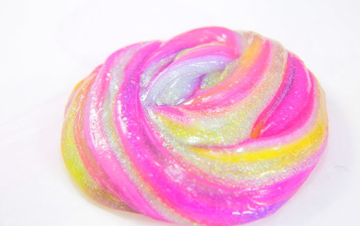 Foolproof slime recipe, striped slime with clear and glitter slime made with glue and contact solution.