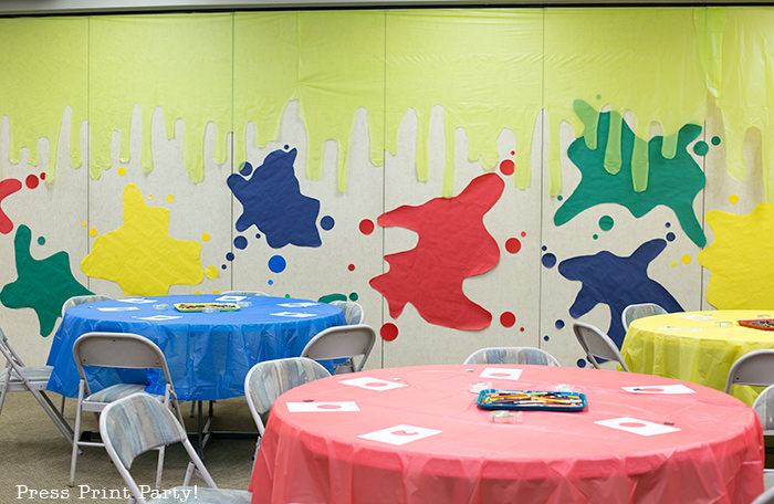 slime walls with paper and plastic tablecloth backdrop -Science party decoration ideas DIY -Press Print Party!