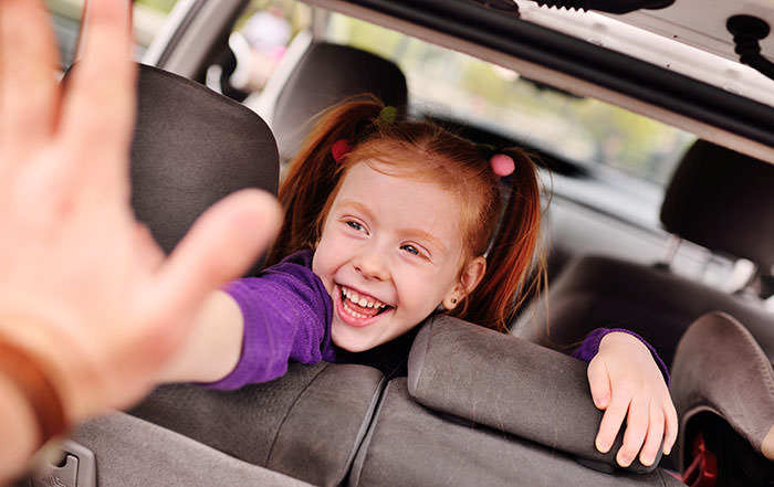 girl laughing in car playing a game - fun games to play in the car