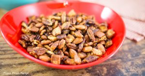 crunchy keto trail mix recipe with catalina crunch cereal, almonds, cocoa nibs, serve, and pecans. In a red bowl