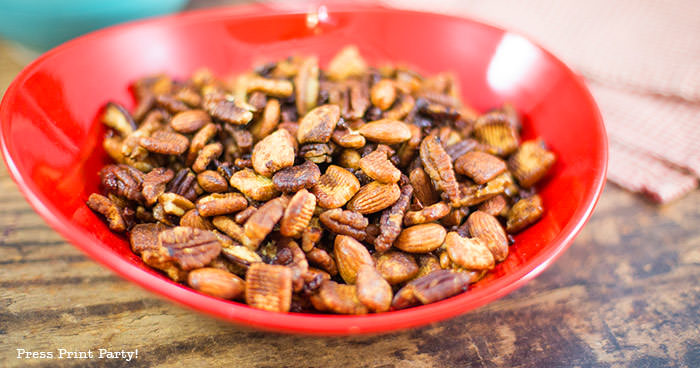 crunchy keto trail mix recipe with catalina crunch cereal, almonds, cocoa nibs, swerve, and pecans. In a red bowl