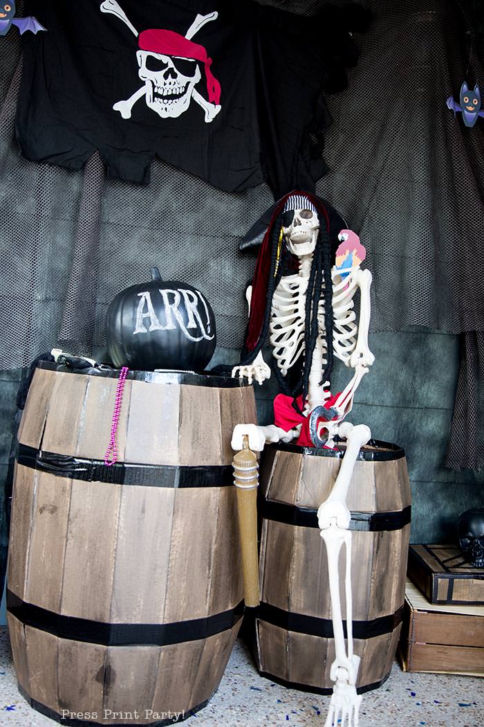 Pirate skeleton with pirate hat and parrot on his shoulder. with a chalkboard pumpkin. Halloween front porch decor ideas - Press Print Party!