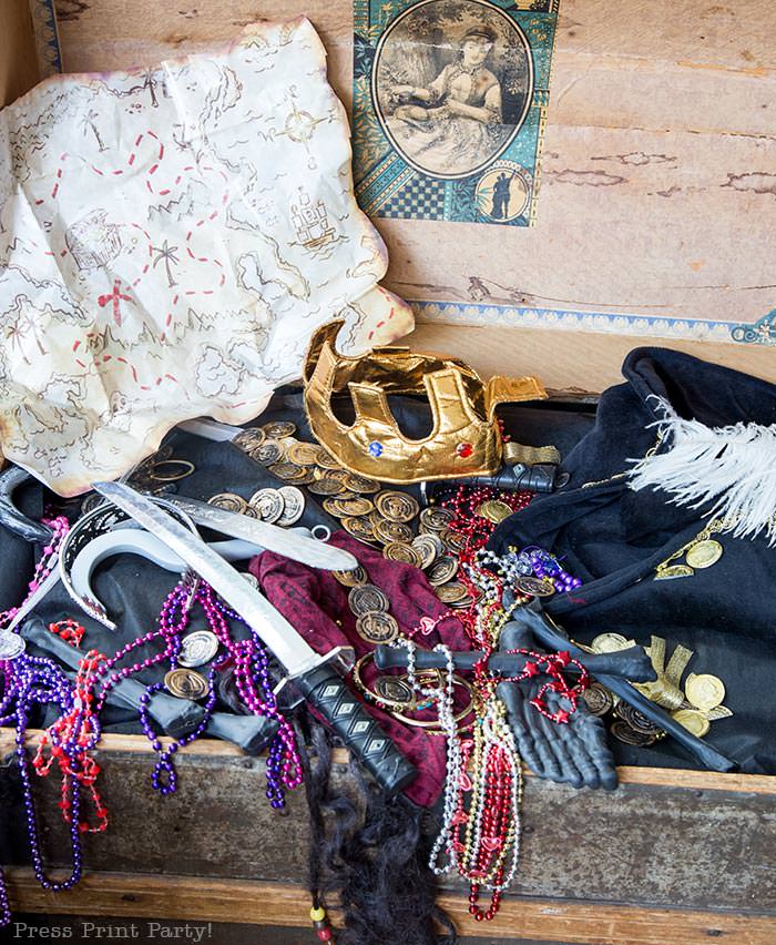 Pirate treasure chest with treasure map. crown, pirate hat and necklaces- Halloween porch decor ideas- DIY pirate ship- Halloween pirate decorations - Press Print Party