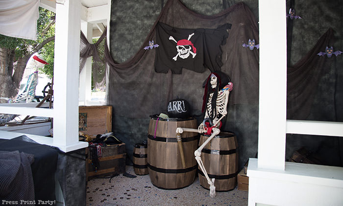 Pirate skeleton with pirate hat and parrot on his shoulder. with a chalkboard pumpkin. Halloween front porch decor ideas - Press Print Party!