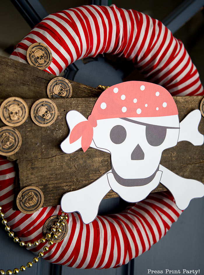 Halloween wreath pirate wreath diy with pirate coins and red and white striped fabric. free pirate skull and crossbone printable - Press Print Party!