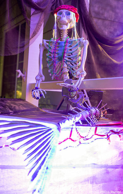 skeleton mermaid on DIY pirate ship made out of cardboard. halloween front porch decoration idea. night lighting LED purple light - Press Print Party!