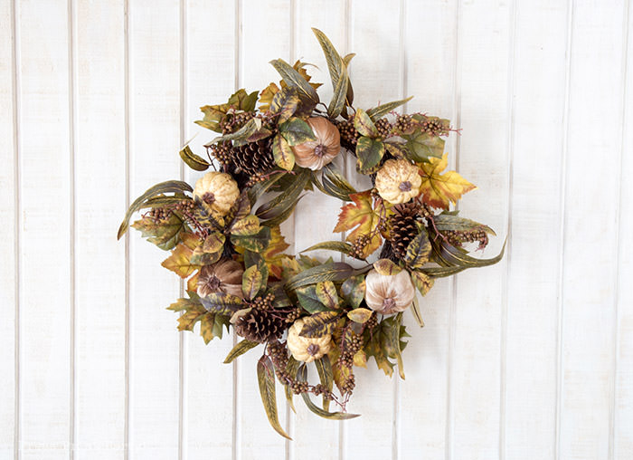 Golden Farmhouse Decorations for Thanksgiving Table. Get inspired with Thanksgiving table decor ideas. White wooden walls with gilded wreath and gold chargers, white plates, black pumpkin place cards, black lantern, golden pumpkins, votives, decorations for thanksgiving table, farmhouse decor ideas, Friendsgiving ideas, thanksgiving table decor, Thanksgiving table setting - tablescape. Press Print Party!