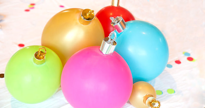 close up of balloon ornament for Christmas table centerpiece. Balloons with ornament toppers in green, gold, blue, red and hot pink. Press Print Party!