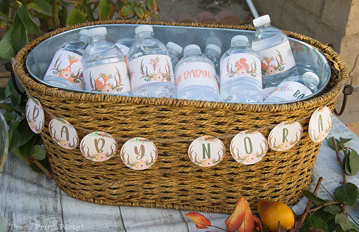 Woodland baby shower bottle wrappers printables and mini banner with baby's name editable- Woodland animals Baby Shower Theme with woodland creatures and forest animals party supplies. Woodland decoration girl baby shower ideas. Can be used for woodland birthday party. Rustic forest animals with flowers and antlers. Fox baby shower, Deer baby shower.