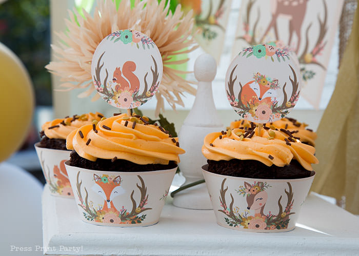 woodland baby shower cupcake toppers and wrappers printable. Chocolate cupcakes with orange frosting and chocolate sprinkles. Woodland animals Baby Shower Theme with woodland creatures and forest animals party supplies. Woodland decoration girl baby shower ideas. Can be used for woodland birthday party. Rustic forest animals with flowers and antlers. Fox baby shower, Deer baby shower.