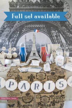 Paris Party theme decorations desert table with paris party printables. Eiffel tower backdrop and centerpiece with cupcakes and french flag. Vintage French Party decorations and treats. With Paris banner and red whit and blue balloons. Press Print Party!