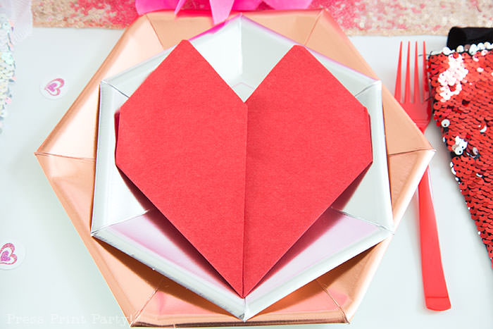 Red heart napkin fold on rose hexagonal metallic plate and silver plate - Galentine's Day Party Ideas for Teens - Press Print Party!