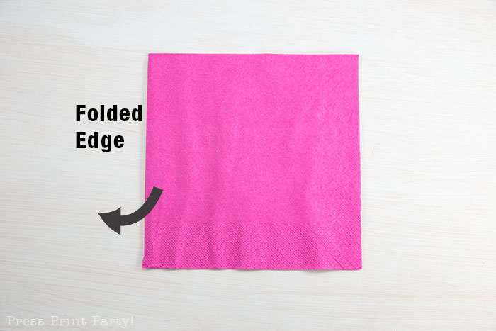 Heart Fold Napkin instructions- How to fold a napkin like a heart - paper napkin or cloth napkins - By Press print Party. Pink paper napkin folded like a heart DIY tutorial