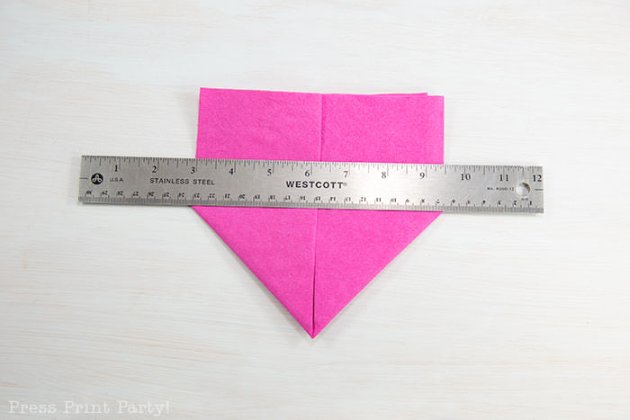 Heart Fold Napkin instructions- How to fold a napkin like a heart - paper napkin or cloth napkins - By Press print Party. Pink paper napkin folded like a heart DIY tutorial